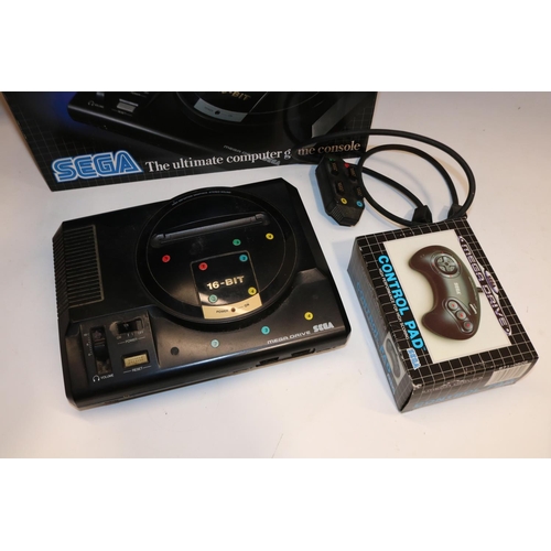 376 - Sega Mega Drive 1 TV games console with control pad, Sega Mega Drive Master System Converter, and a ... 