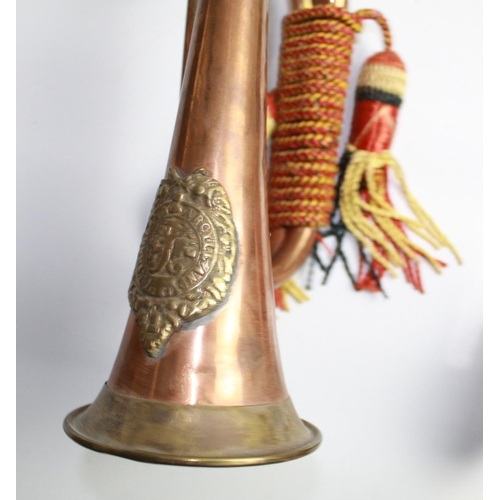 Three Military brass and copper bugles decorated with rope