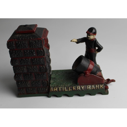 629 - Cast iron money box showing an Artillery officer firing a cannon. THE ARTILLERY BANK