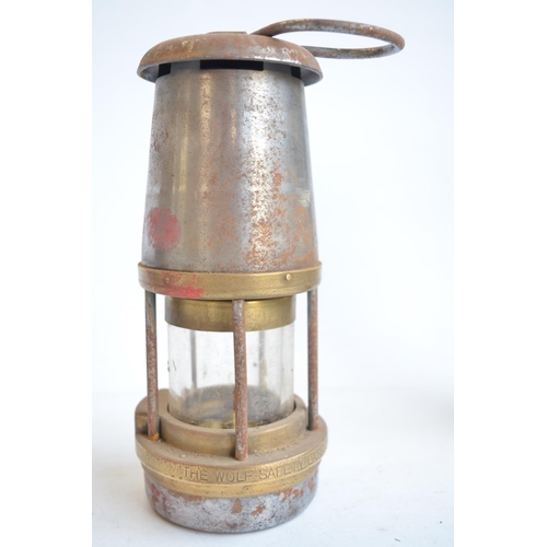 463 - Four vintage metal lamps to include Wolf Safety Lamp, a Type 6 Eccles safety lamp by The Protector L... 