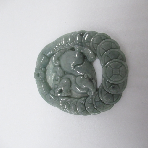 189 - Jade carved pendant with Foo dog surrounded by shield border, with certificate of identification fro... 