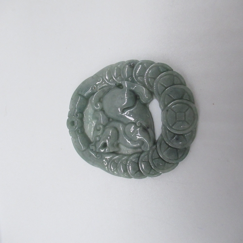 189 - Jade carved pendant with Foo dog surrounded by shield border, with certificate of identification fro... 