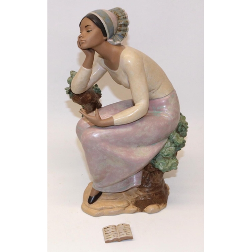 119 - Lladro figure - 'Poetic Moment, #12299, modelled as a woman seated on a tree stump with book, H32cm,... 