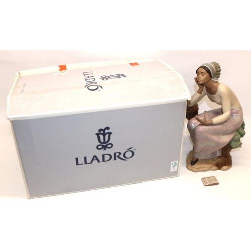 119 - Lladro figure - 'Poetic Moment, #12299, modelled as a woman seated on a tree stump with book, H32cm,... 