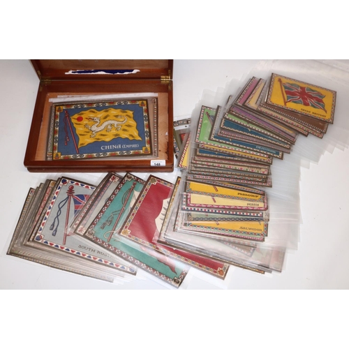 148 - Collection of approximately 65 USA cigar box flags, in wooden box.