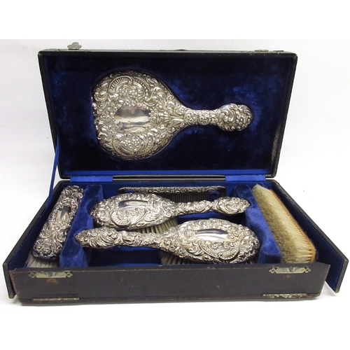 157 - Cased Edwardian silver vanity travel set with mirror, four brushes & comb, cased in a blue velvet in... 