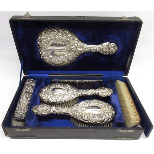 157 - Cased Edwardian silver vanity travel set with mirror, four brushes & comb, cased in a blue velvet in... 