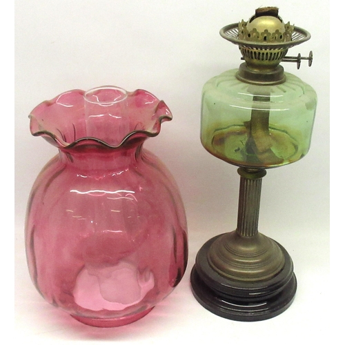 198 - Late Victorian paraffin oil lamp with green tinted reservoir, fluted column on circular moulded blac... 