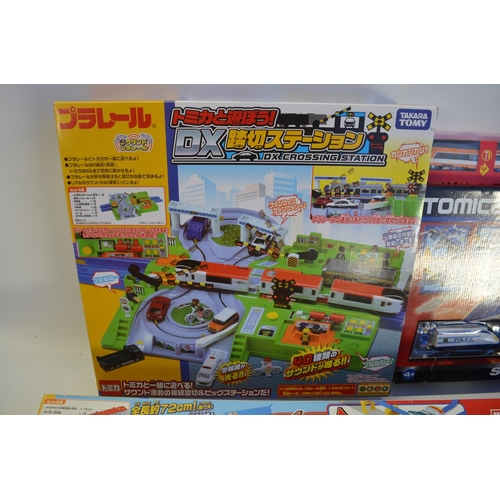 1315 - Collection of Takara Tomy battery powered plastic model train sets to include trains packs, layout s... 