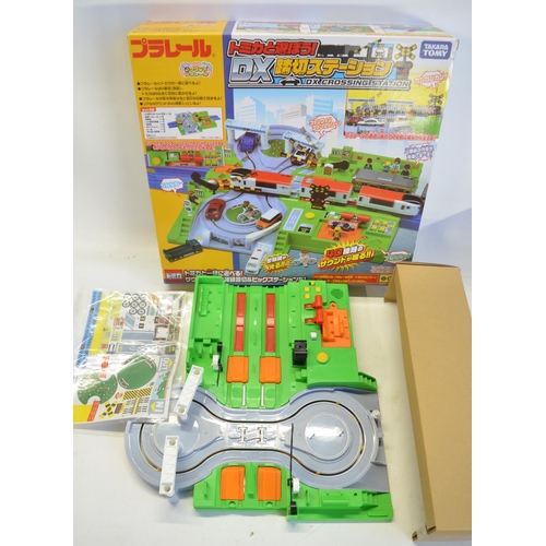 1315 - Collection of Takara Tomy battery powered plastic model train sets to include trains packs, layout s... 