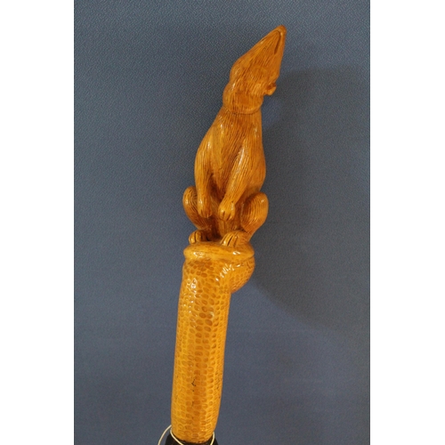 1173 - David Hames - a walking stick with twist carved shaft and rodent carved handle, signed on metal ferr... 