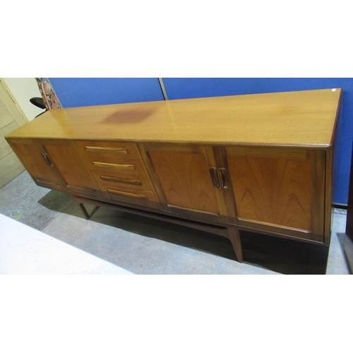 1215 - Victor. B. Wilkins for G-plan, Fresco teak sideboard with four drawers flanked by twin door cupboard... 