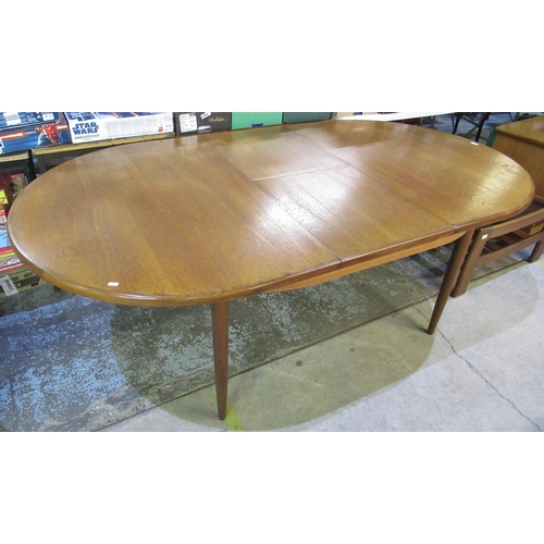 1216 - G-plan teak rounded rectangular extending dining table, on turned supports, W210cm D112cm H73cm and ... 