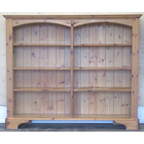 1052 - Modern pine open bookcase, with arched frieze and six shelves on bracket feet, W147cm, D32cm, H123cm