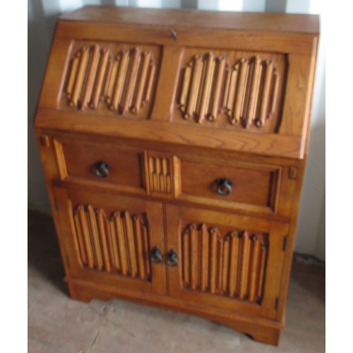 1199 - Light oak bureau, with linen fold detail, fall front with fitted interior above drawer and two doors... 