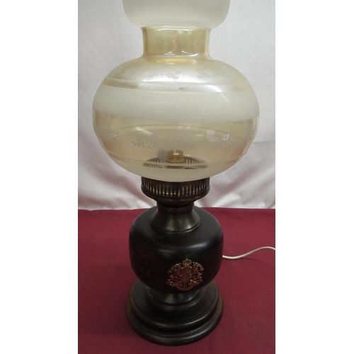 1327 - Oil lamp converted to electric with wooden base and brass crests (missing chimney)