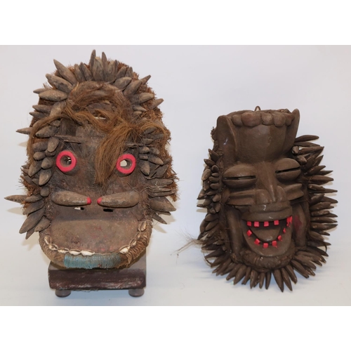 1031 - Two wooden African tribal masks, and a display stand, max. H35cm