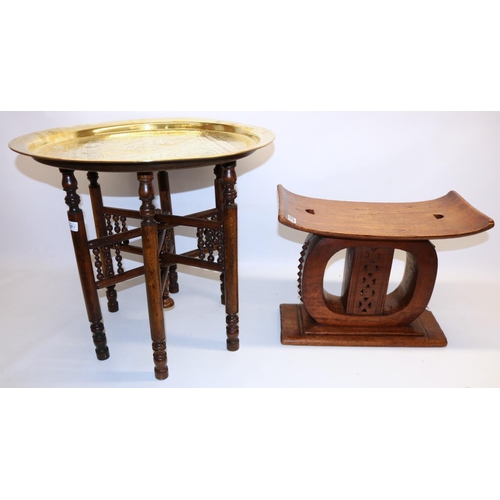 1037 - African ashanti type stool, H37cm; and a Middle Eastern style circular brass topped table with foldi... 