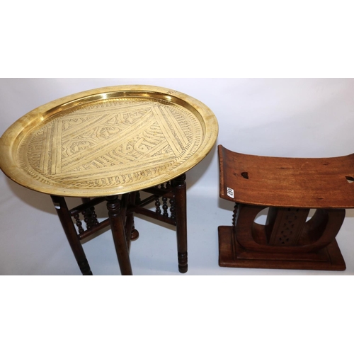 1037 - African ashanti type stool, H37cm; and a Middle Eastern style circular brass topped table with foldi... 