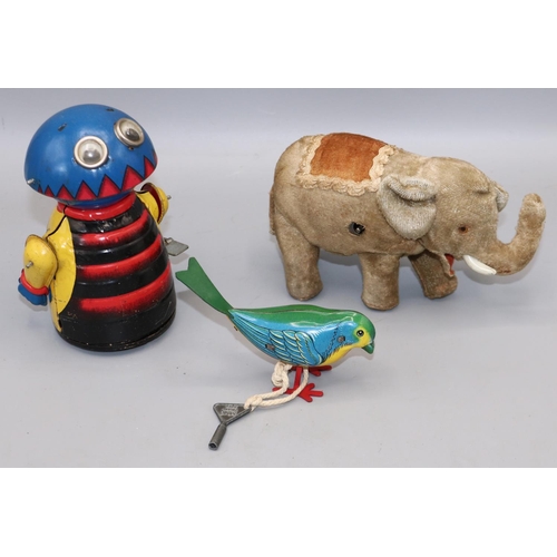 243 - Clockwork toys - a plush elephant, H9cm; a Marx tinplate alien, H13.5cm; and a similar Minic bird, H... 