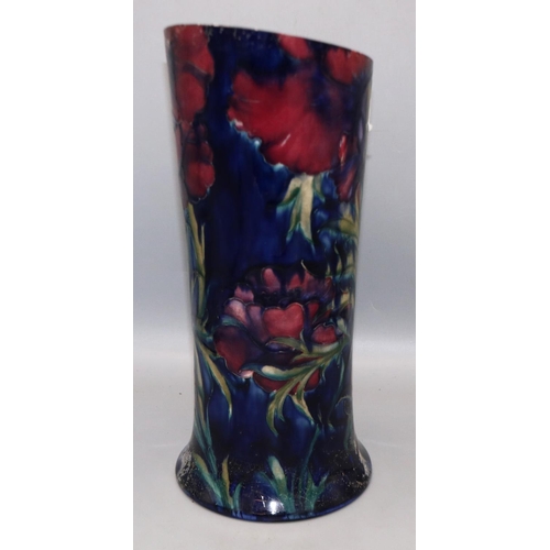 322 - Moorcroft Pottery: cut down vase, with red flowers on dark blue ground, H34cm, A/F