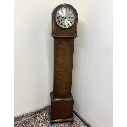 311 - Hamburg American Clock Co., oak grand daughter longcase clock, silvered Roman dial, two train Westmi... 