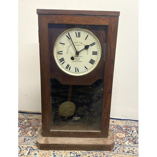 314 - The Gledhill-Brook Time Recorders Ltd Patent - early C20th eight day oak wall/shelf clock, full leng... 