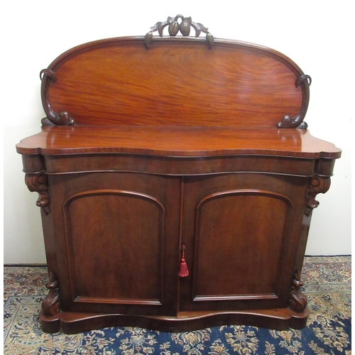 672 - Victorian mahogany serpentine front Chiffonier, arched back with carved cresting above two doors on ... 