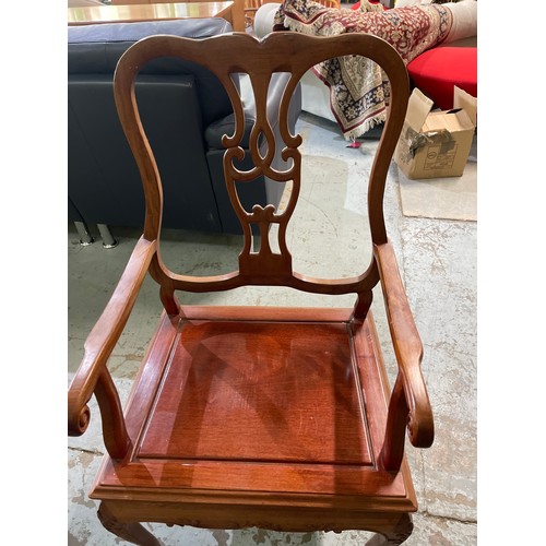 664 - C20th Chinese hardwood armchair with solid seat and carved detail