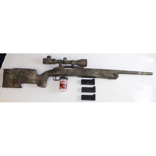 544 - Bolt action spring loading air soft urban snipers rifle. With scope, three magazines, and a jar of p... 