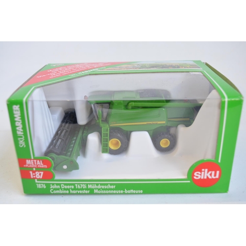 259 - Nine boxed 1/87 scale (HO gauge) diecast farming models from Siku to include 1876 John Deere combine... 