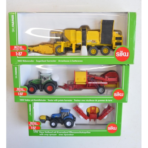 259 - Nine boxed 1/87 scale (HO gauge) diecast farming models from Siku to include 1876 John Deere combine... 