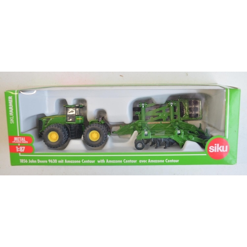 259 - Nine boxed 1/87 scale (HO gauge) diecast farming models from Siku to include 1876 John Deere combine... 