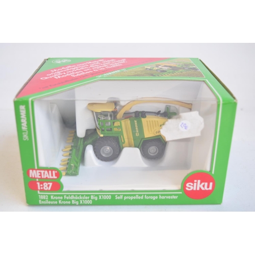 260 - Nine boxed 1/87 scale (HO gauge) diecast farming models from Siku to include 1882 Krone self propell... 