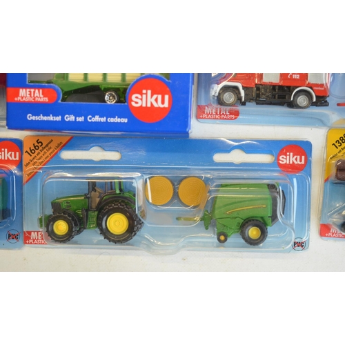 261 - Twenty four boxed diecast vehicle models from Siku to include farming, commercial, emergency etc. Al... 