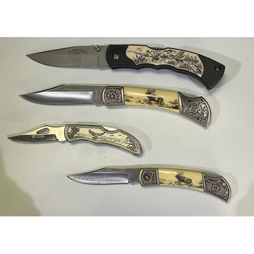 596 - Collection of presentation knifes of various sizes with scrimshaw style etching including stags, eag... 