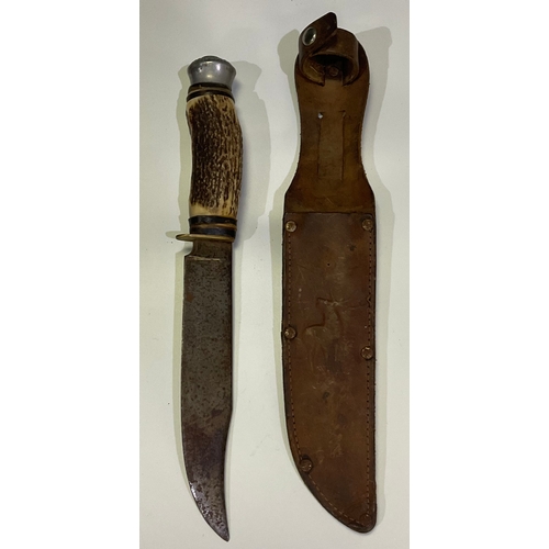 603 - A Bowie knife with 15cm clip laid antler and leather washers handle by Whitby knife company. Solinge... 