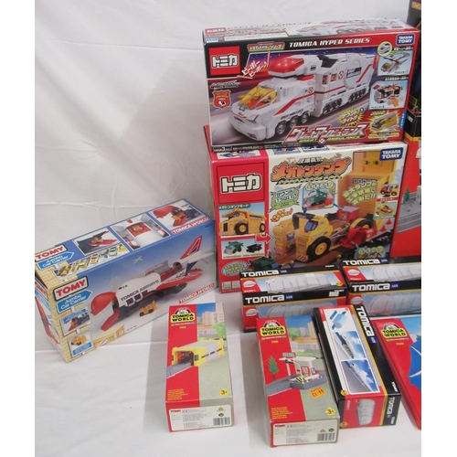 329 - Assorted collection of boxed/cased TOMY toys to include Japanese Import, TOMICA, etc., some sealed o... 