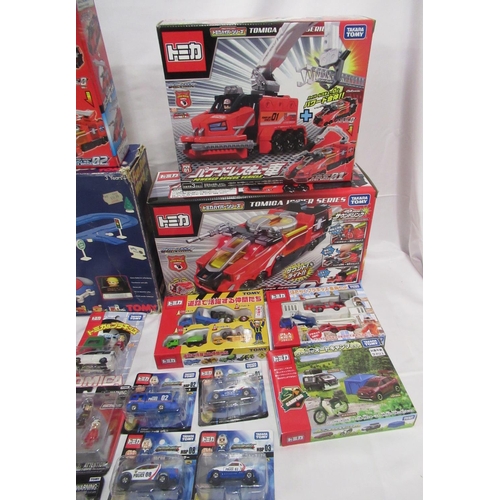 329 - Assorted collection of boxed/cased TOMY toys to include Japanese Import, TOMICA, etc., some sealed o... 