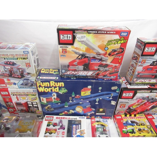 329 - Assorted collection of boxed/cased TOMY toys to include Japanese Import, TOMICA, etc., some sealed o... 