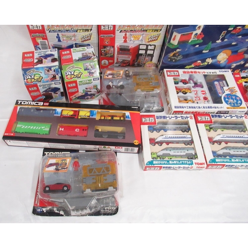 329 - Assorted collection of boxed/cased TOMY toys to include Japanese Import, TOMICA, etc., some sealed o... 