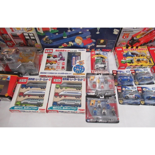 329 - Assorted collection of boxed/cased TOMY toys to include Japanese Import, TOMICA, etc., some sealed o... 