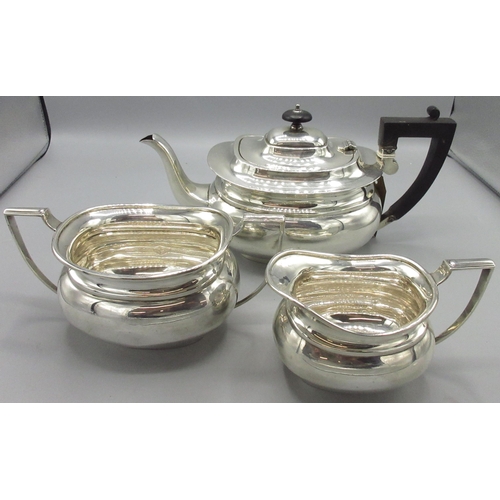 66 - George V Art Deco silver matched three piece tea service, teapot with ebonised handle and final, twi... 