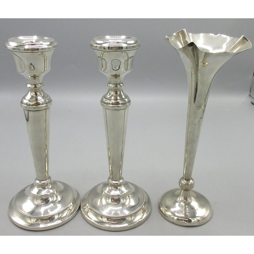 69 - Pair of 20th century silver candle sticks with tapered centre and circular weighted bases with repea... 