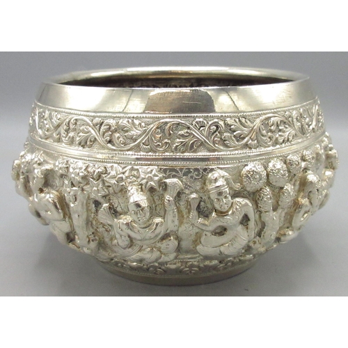 C20th white metal Indian bowl in the Burmese style, compressed tapering circular form with intricate repousse decoration, base engraved with a heron catching fish, likely the makers signature, H9cm, W11.21ozt