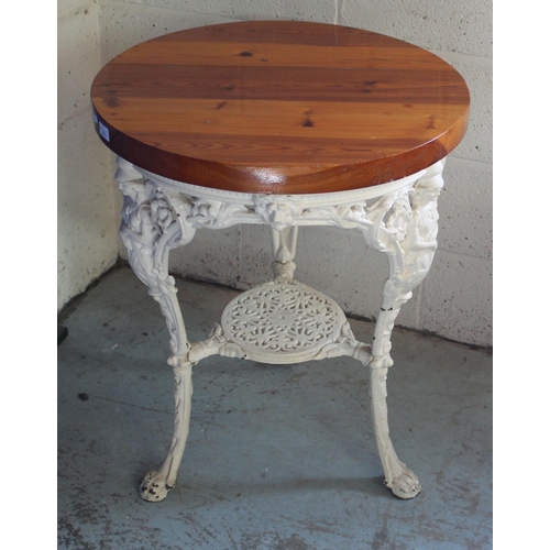 685 - Conservatory table, circular pine top on three Britannia cast metal supports with undertier, D60cm H... 