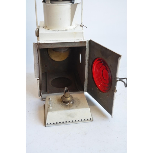 142 - Railway paraffin lamp, white BR(W) example (height with handle raised approx 53cm) and a red painted... 