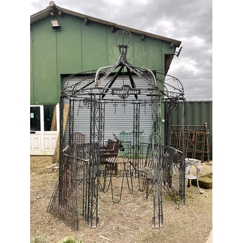 1252 - Large ornate Victorian style steel pergola gazebo with seating and table to match. With plant hangin... 