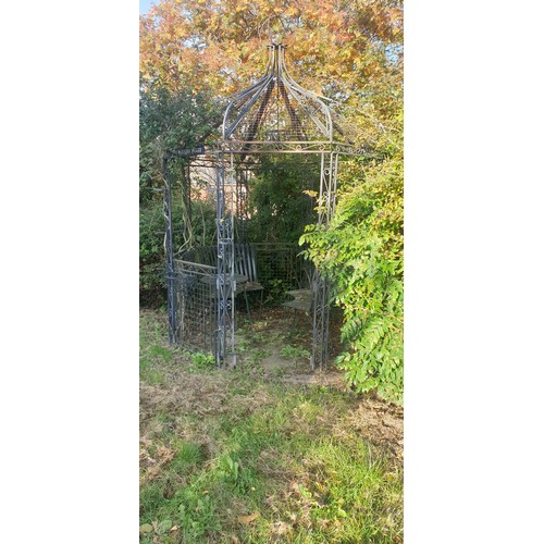 1252 - Large ornate Victorian style steel pergola gazebo with seating and table to match. With plant hangin... 