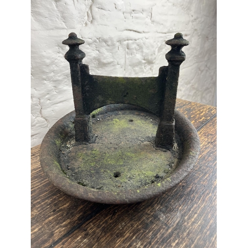 130 - Black painted cast iron boot scraper on oval base, L35cm